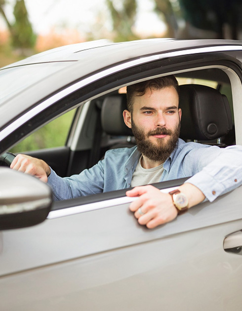 A right close up of a yellow Mercedes AMG sports car headlight on a city street