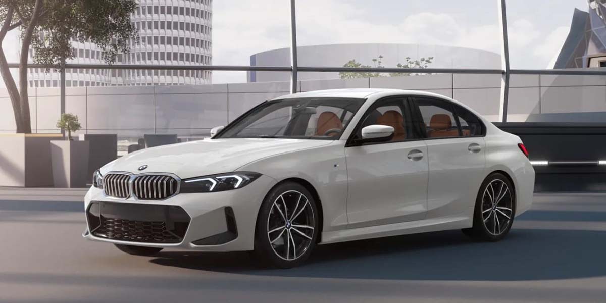 A sleek white sedan parked in a modern urban setting, featuring stylish alloy wheels and a streamlined design, conveys luxury and sophistication.