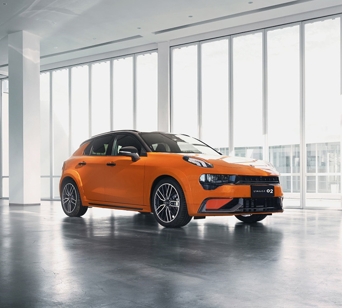 A right close up of a yellow Mercedes AMG sports car headlight on a city street