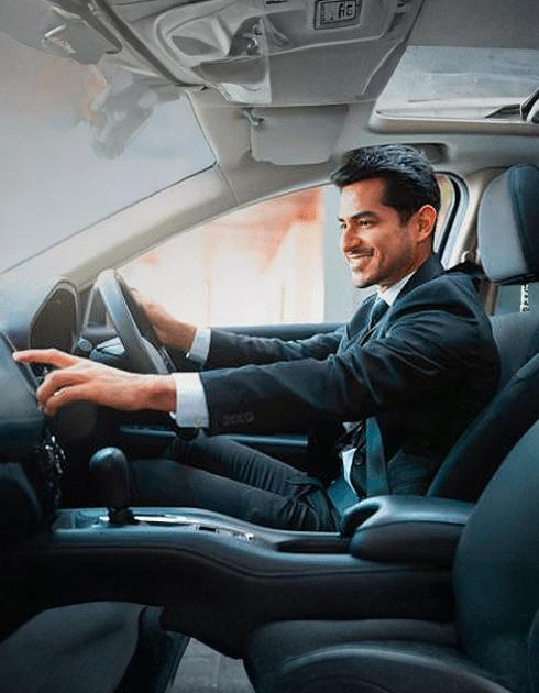 A right close up of a yellow Mercedes AMG sports car headlight on a city street
