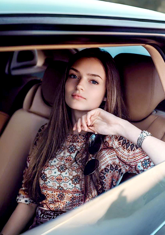 A right close up of a yellow Mercedes AMG sports car headlight on a city street